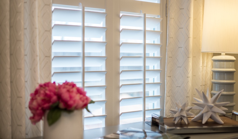 Plantation shutters by flowers in Tampa